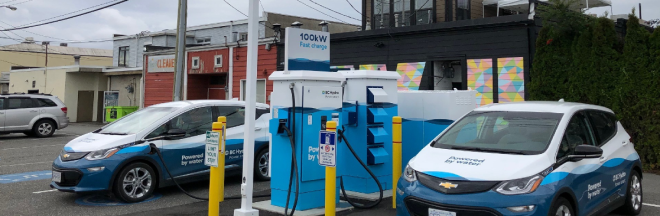 Electric vehicles plugged in at a charging station