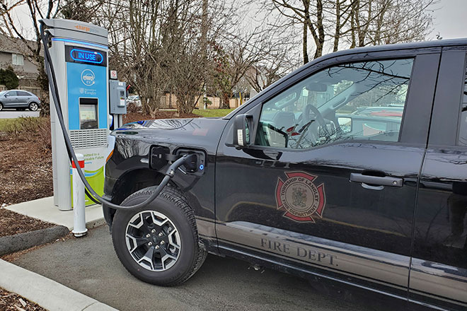 A Langley Fire Department Ford F-150 Lightning connected to an EV charger