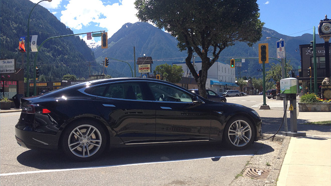 Image of a Tesla EV attached to a charger Image of a Tesla EV attached to a charger