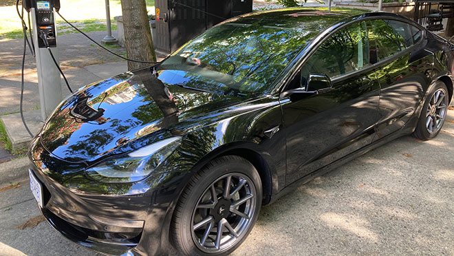 Image of a Tesla charging on a Vancouver street