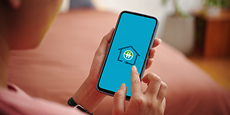 Person looking at a smartphone screen with the HydroHome App logo