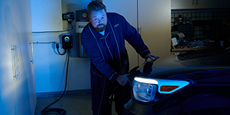 Dave charging a vehicle in a home garage