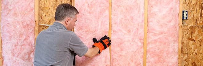 Contractor installing wall insulation