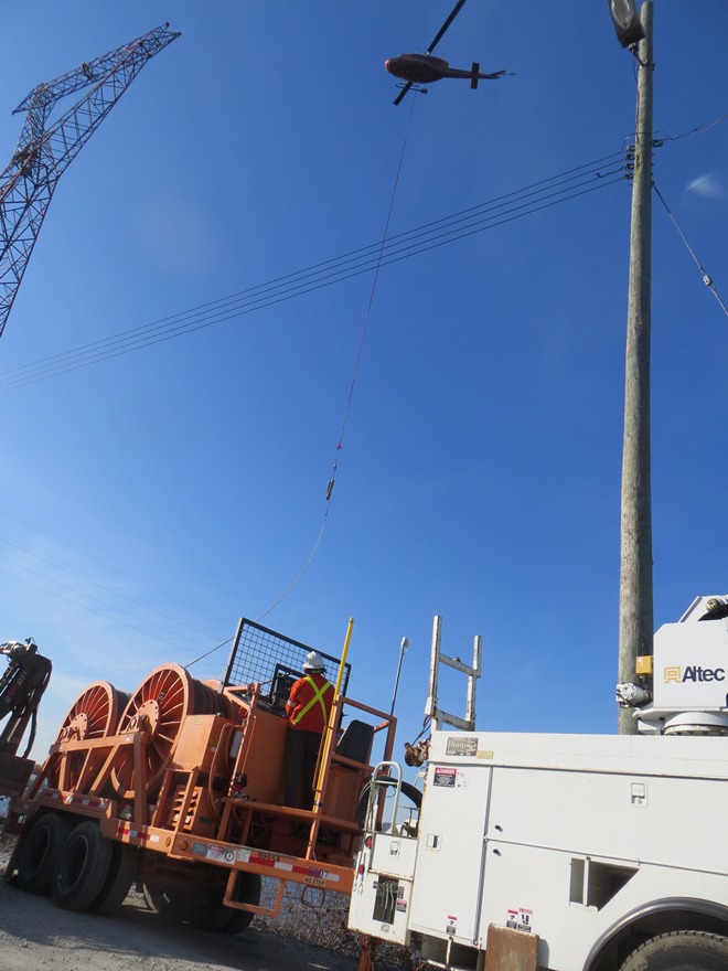 Helicopter helping with contruction of transmission lines over Fraser River