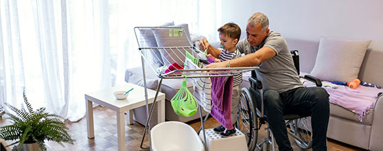 Father and son drying laundry
