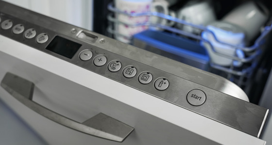 Dishwasher door with buttons.