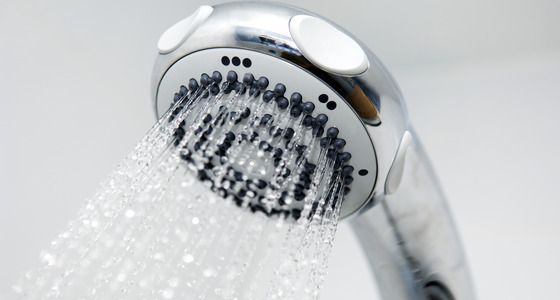 Water coming out of a showerhead faucet.