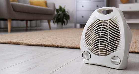 Space heaters on the floor of a room.