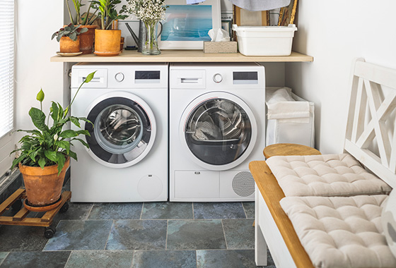 Laundry room with a washer, dryer and decor. 