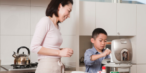 Mother and Son Serving Steamed Rice from Rice Cooker