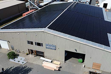 Aerial view of a solar panel-lined roof of a warehouse
