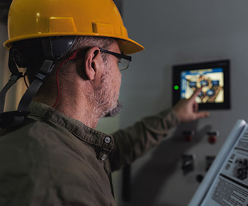 Engineer working on computer to maintain heating and cooling systems