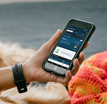 Hand holding a smartphone, showing the HydroHome app
