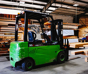 Electric forklift in a lumber mill