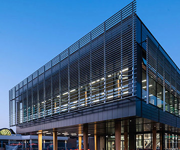 The facade of the Student Housing and Dining building at the University of Victoria, shown in the evening