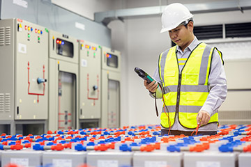 Engineering electrician using a digital tester battery