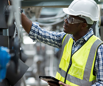 Engineer inspects industrial machinery