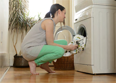 Loading laundry in clothes washer