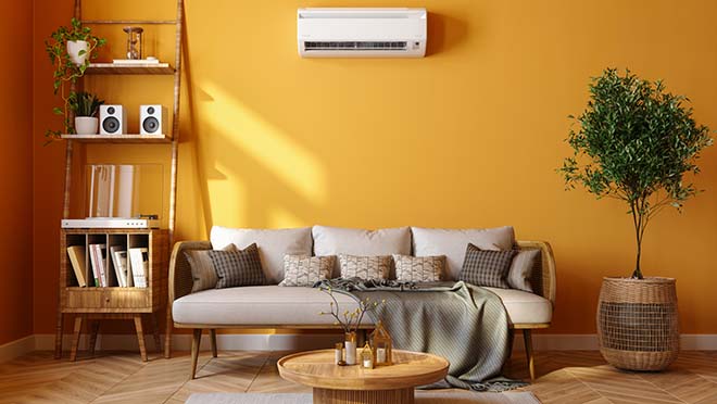 Modern Living Room With Air Conditioner, Sofa, Potted Plant And Yellow Wall