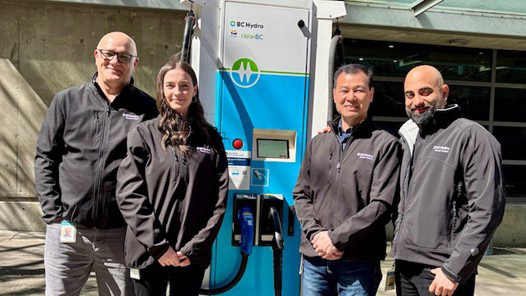 BC Hydro EV team standing beside an EV charger