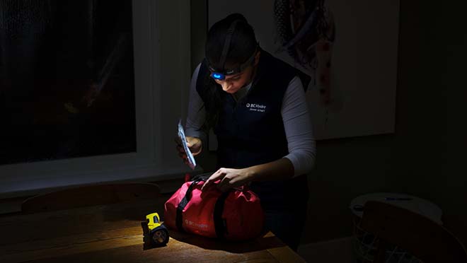 Jaclyn looking inside an emergency kit during an outage