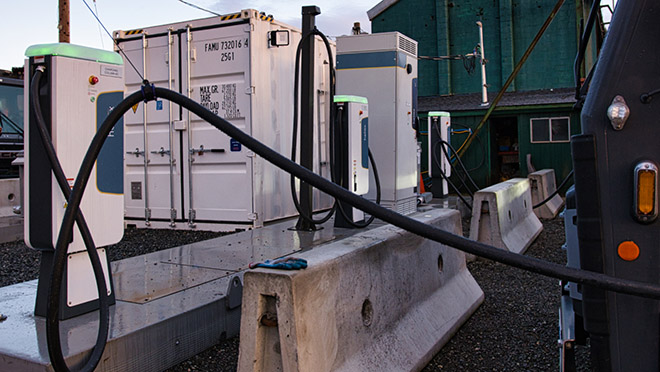 Mack Electric truck plugs with a truck being charged.