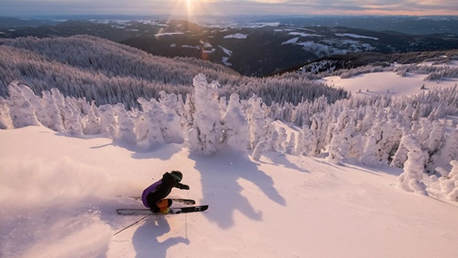 Person skiing down snowy mountain