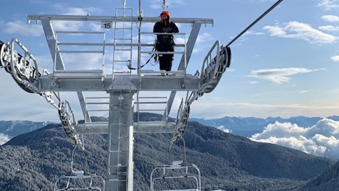 Woman standing at the top of a chairlift