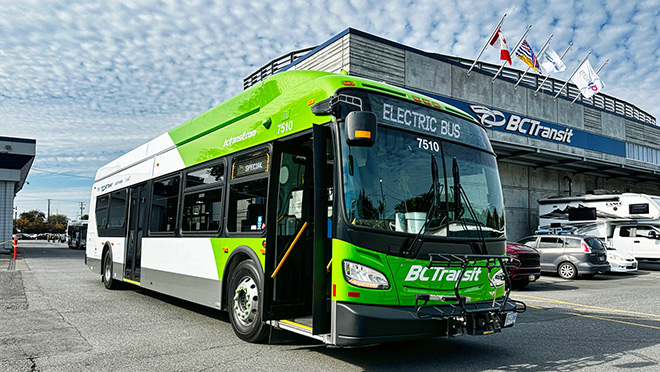 An electric bus in front of a BC Transit building.