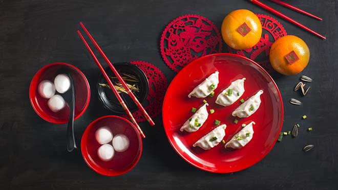 Flat lay Chinese new year food and drink still life. Texts appear in image: Prosperity, spring, good luck.