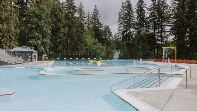 Outdoor pool with lap lanes and water play features.