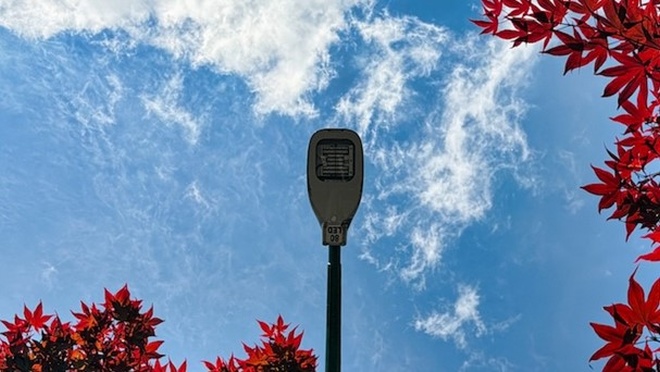 LED streetlight against a blue sky.