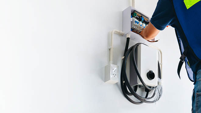 An electrician installing an EV charger