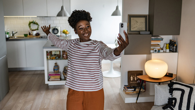 Person on phone showing new kitchen