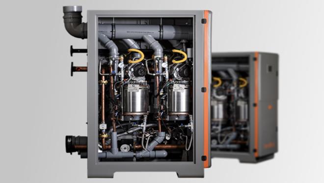 Industrial heat pump water heater system with exposed internal piping and components.