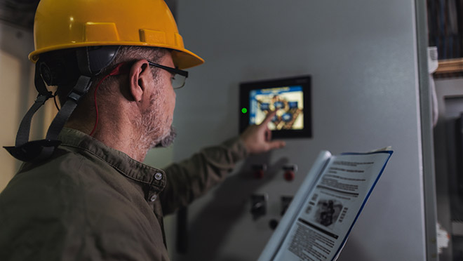 Engineer adjusting a computer panel
